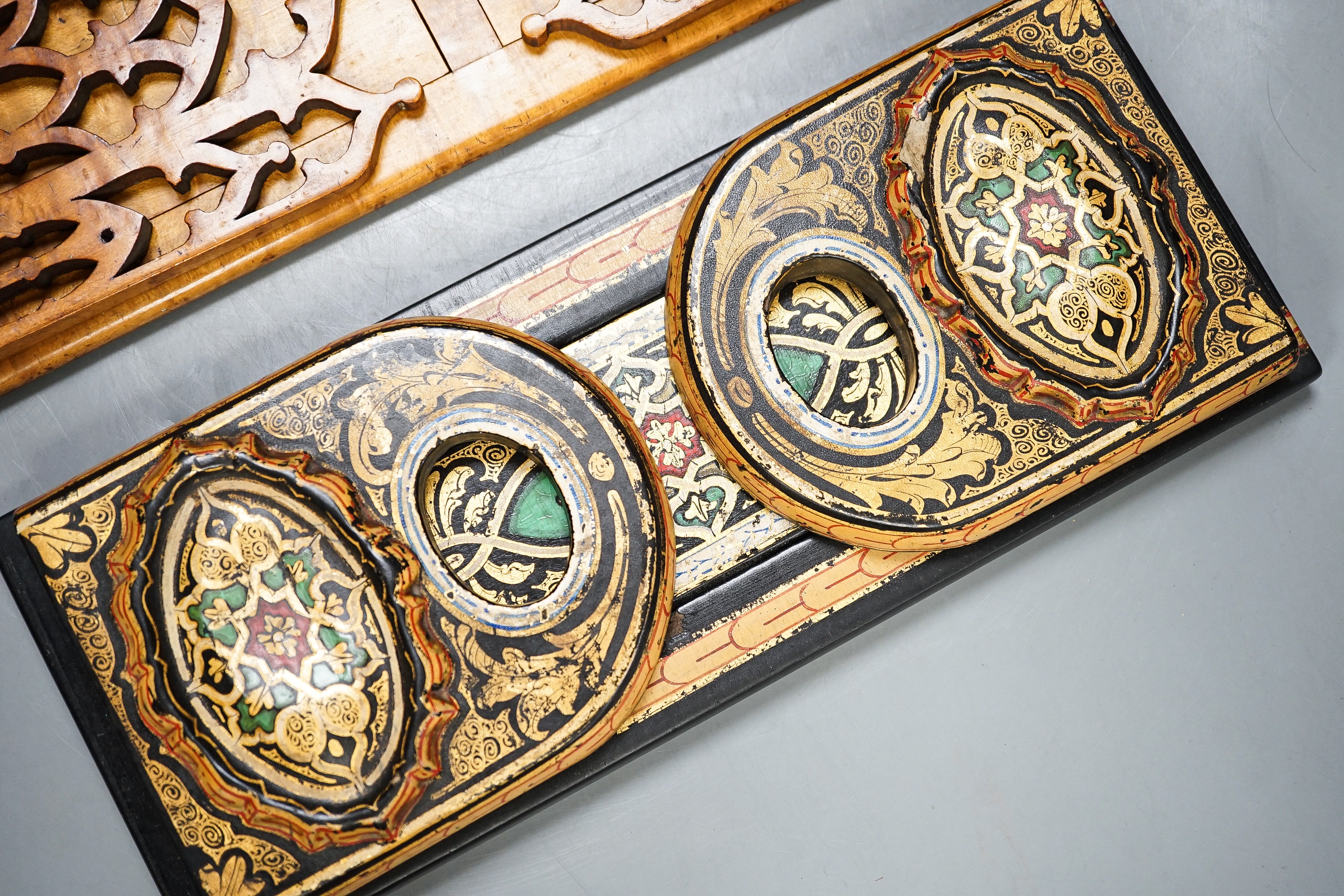A Victorian Pugin style Gothic revival bird’s eye maple bookslide together with a japanned papier-mâché example (2), largest 34cms wide.